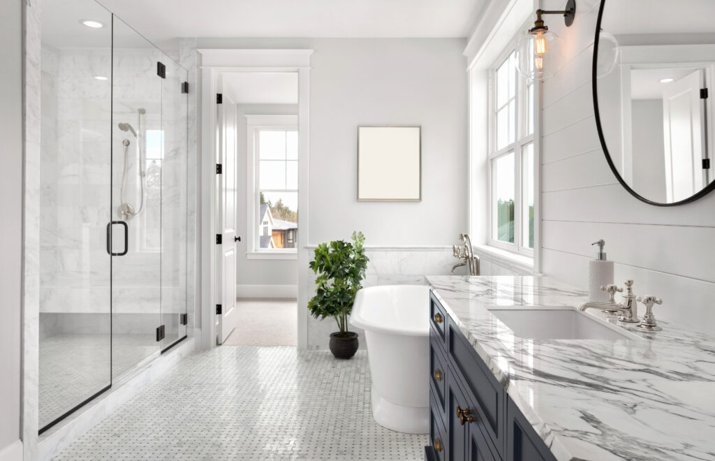 Beautiful Ensuite Master Bathroom in New Luxury Home. Features Elegant Countertop, Bathtub, Shower, and Walk-in Closet